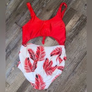 One piece cut out maternity bathing suit with tropical pattern.
